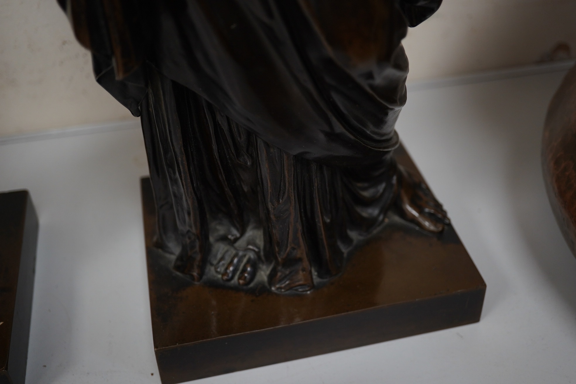 Eugene-Antoine Aizelin (French, 1820-1902). A pair of bronze classical robed figures of Pandora and Hebe, one holding a casket, the other a ewer and cup, having dark brown patination Height 50cm on square plinth base, si